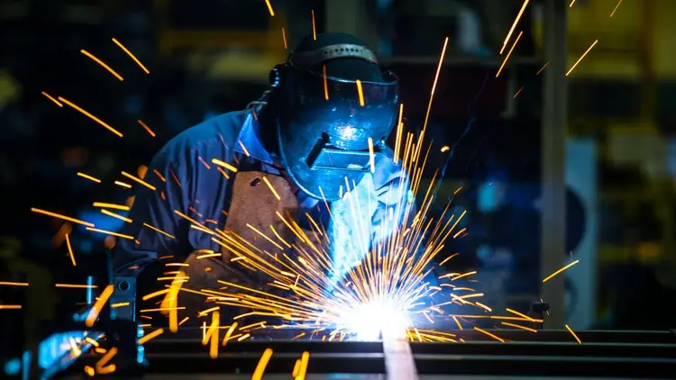 Welder at work with sparks